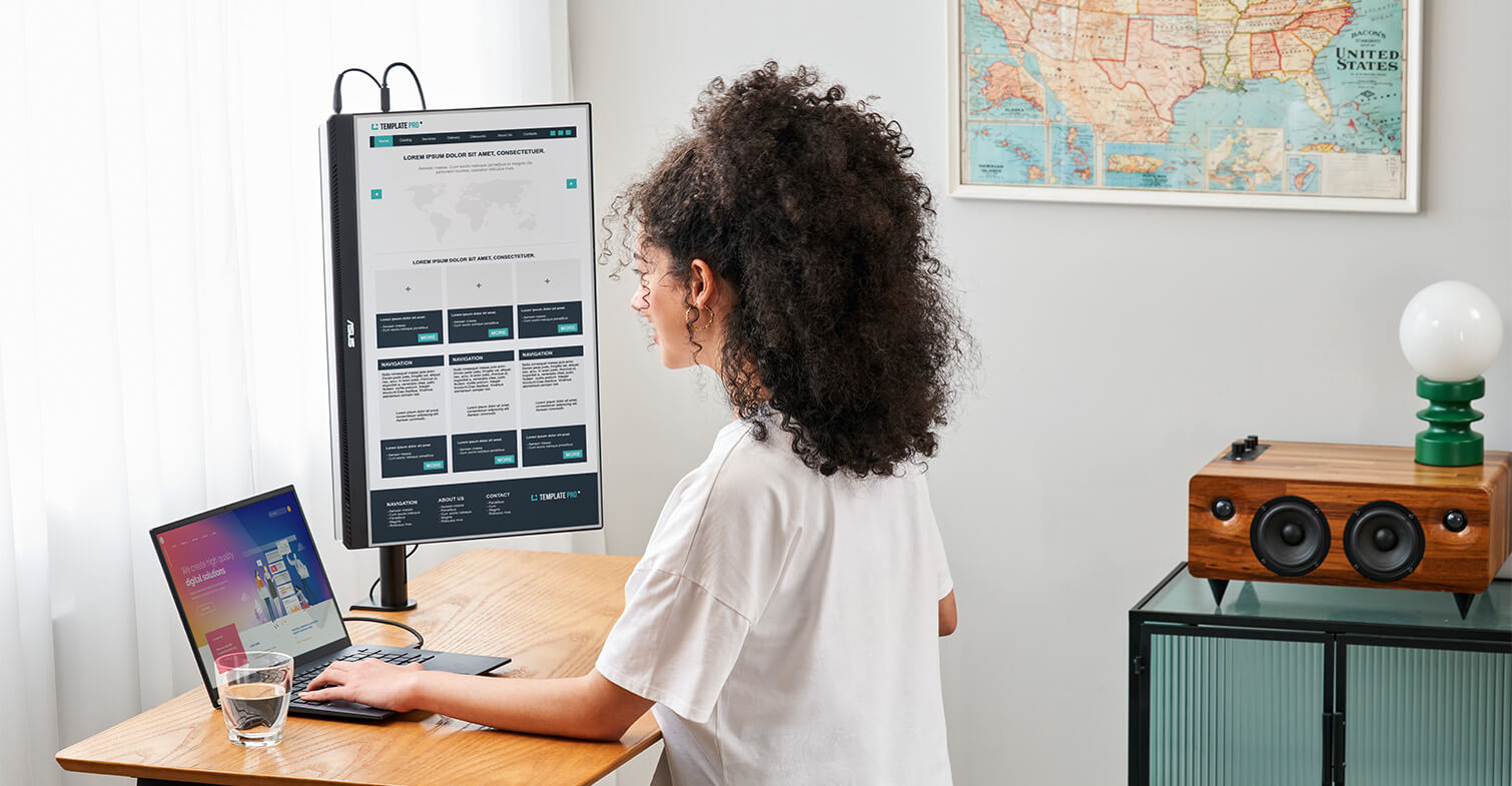 A woman works from home using ZenScreen MB249C in portrait mode with C-clamp arm on small study table