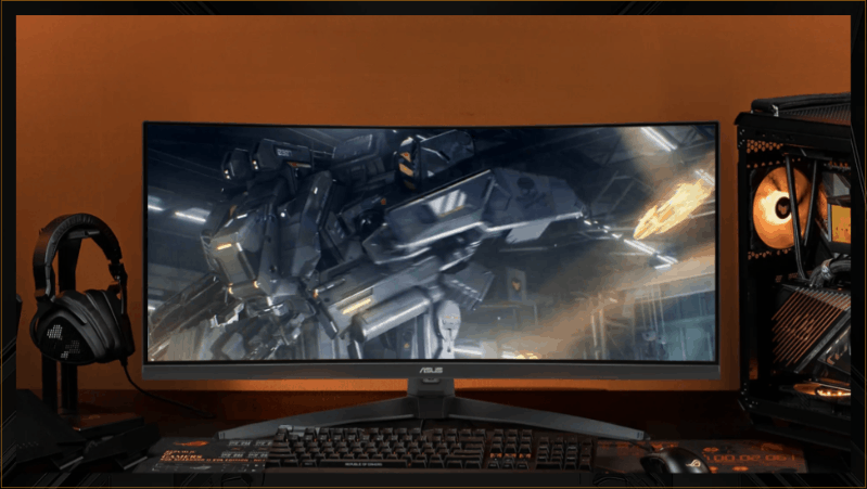 A VG34WQ5A monitor centered in frame, with a keyboard positioned in front, headphones to the left, and a computer tower to the right.
