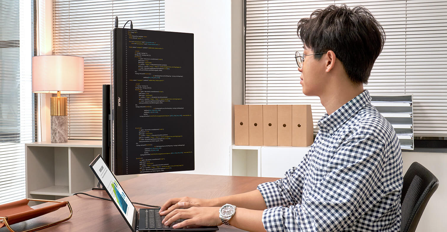 An Engineer work in office with a laptop and ZenScreen MB249C on portrait mode