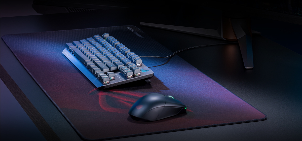 The ROG Strix Scope RX TKL Wireless Deluxe in wired mode, sitting on the Scabbard II mousepad and accompanied by the Chakram X mouse