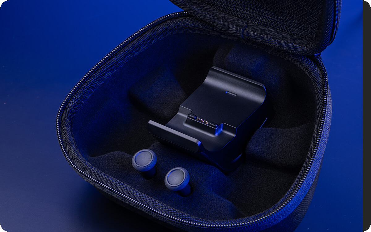 Portable case, charging stand with feet, and two joystick caps