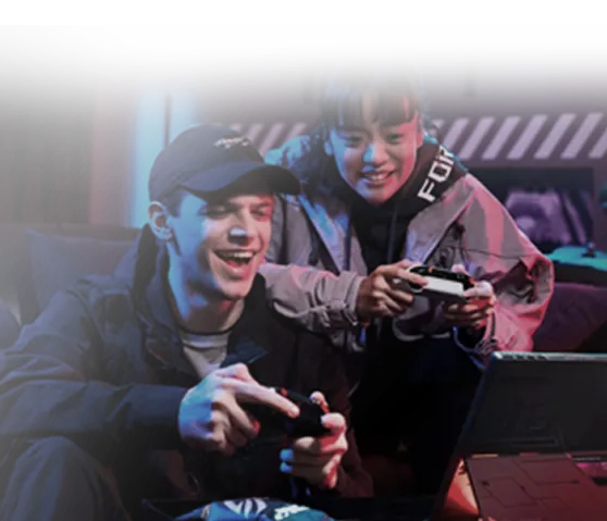 Two gamers playing with controllers in front of an ROG laptop